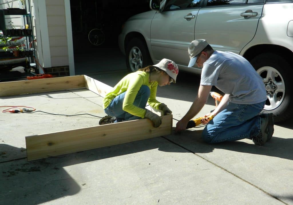 Want to make your own DIY Raised Garden Bed? This step-by-step tutorial will help get your garden up and growing in no time!