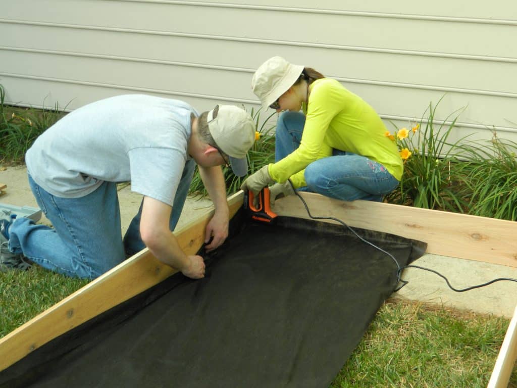 Want to make your own DIY Raised Garden Bed? This step-by-step tutorial will help get your garden up and growing in no time! width=