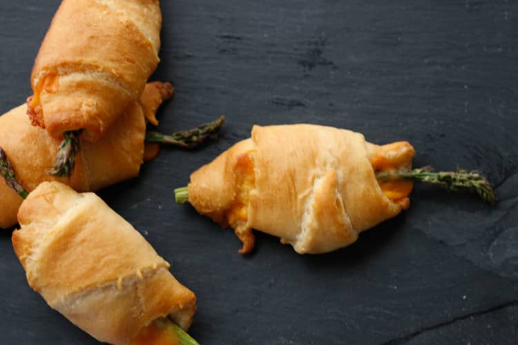 These four ingredient cheese and asparagus stuffed crescent rolls are delicious, easy, and great for the whole family to enjoy!