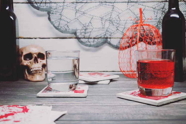 Serve your delicious drinks on these bloody coasters this Halloween! This blood-splattered coaster DIY with ceramic tiles is super easy and inexpensive!