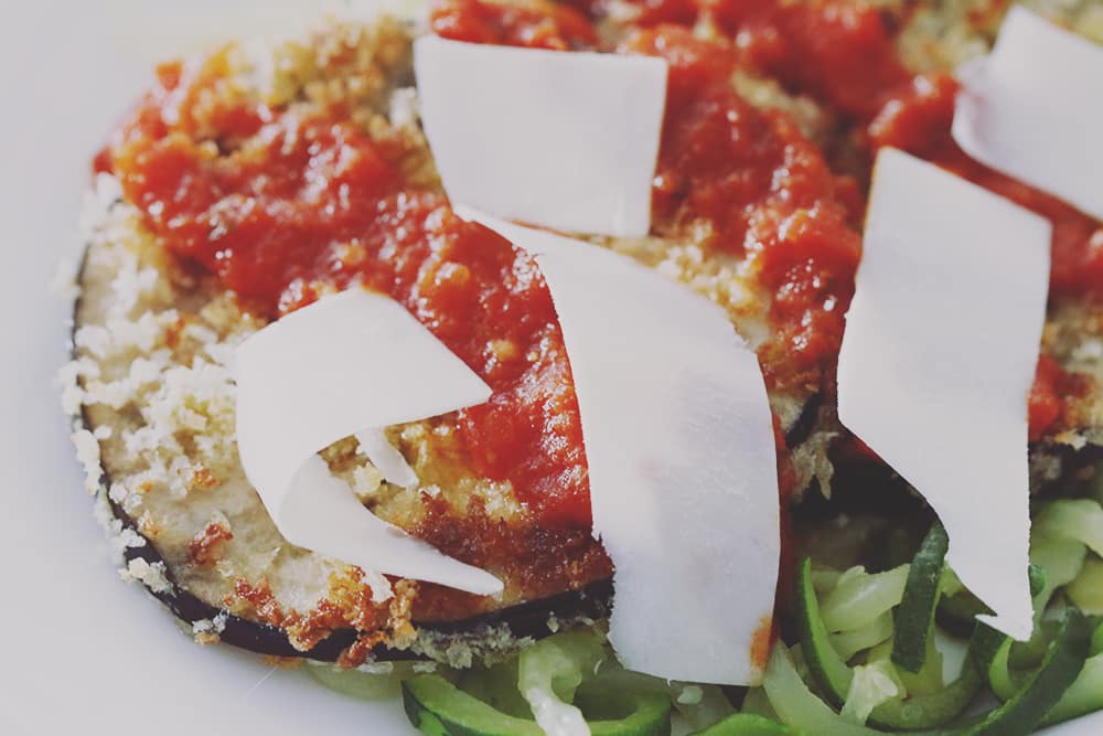 A simple and healthy twist on Eggplant Parmesan with zucchini noodles in place of regular noodles. Easy to make and delicious to eat!