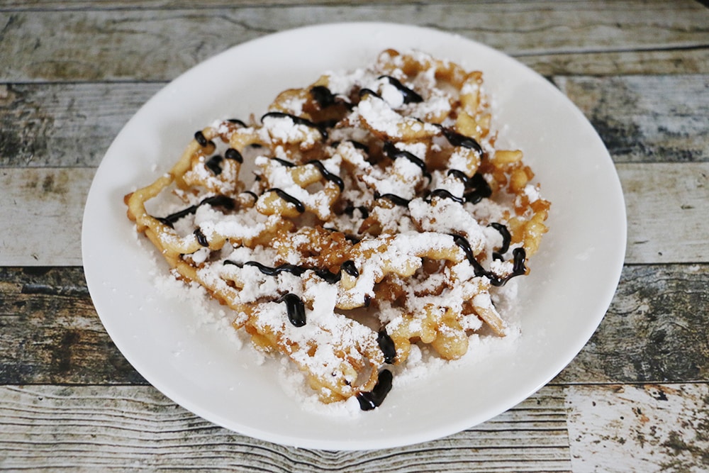 This simple funnel cake recipe will make sure that you never miss carnival funnel cakes! You'll feel like you were at the fair every time you make these!