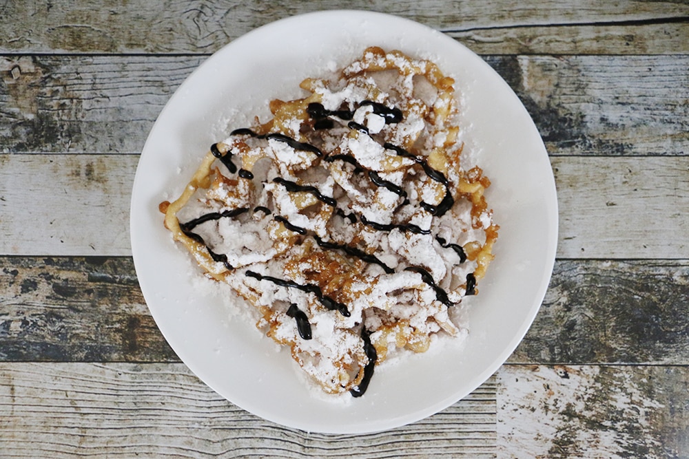 This simple funnel cake recipe will make sure that you never miss carnival funnel cakes! You'll feel like you were at the fair every time you make these!