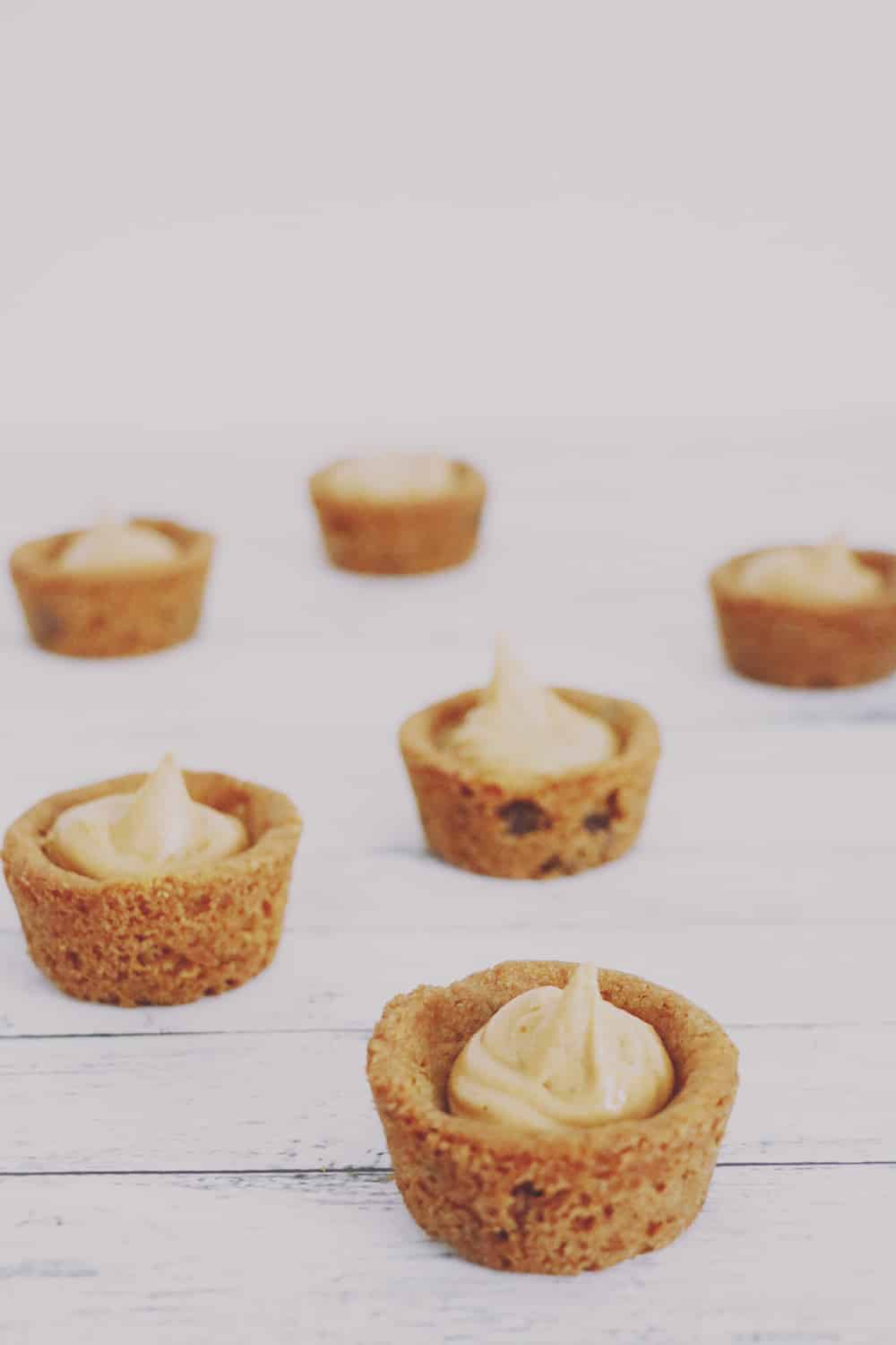 What could be better than peanut butter chocolate chip pies? Mini peanut butter chocolate chip pies! These little morsels are SUPER easy + delicious, too!