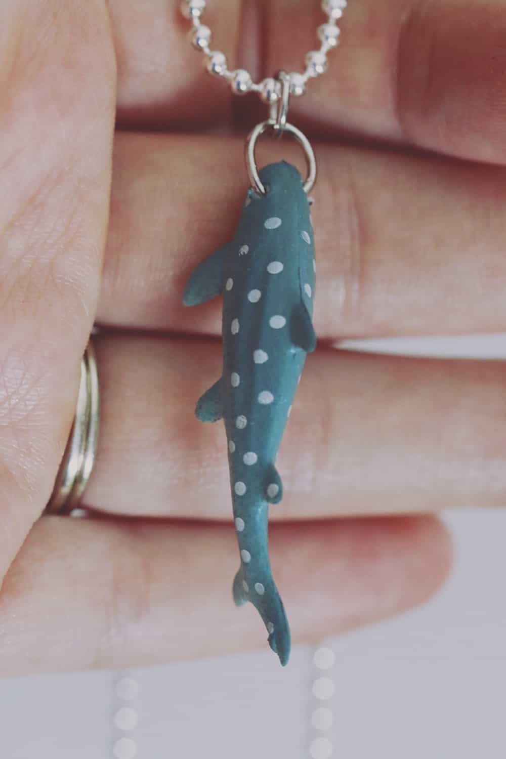 Celebrate shark week and shark awareness day with this fun and easy shark necklace DIY! You'll be ready to share your love for the ocean in no time!