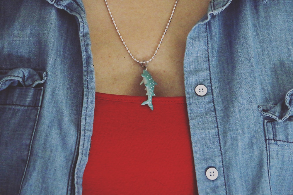 Celebrate shark week and shark awareness day with this fun and easy shark necklace DIY! You'll be ready to share your love for the ocean in no time!