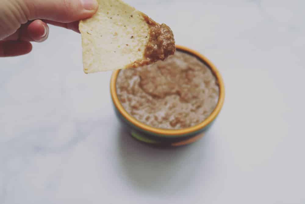 This simple slow cooker bean dip is perfect for game day snacking. Just a few ingredients and hours later you've got a deliciously easy dish!