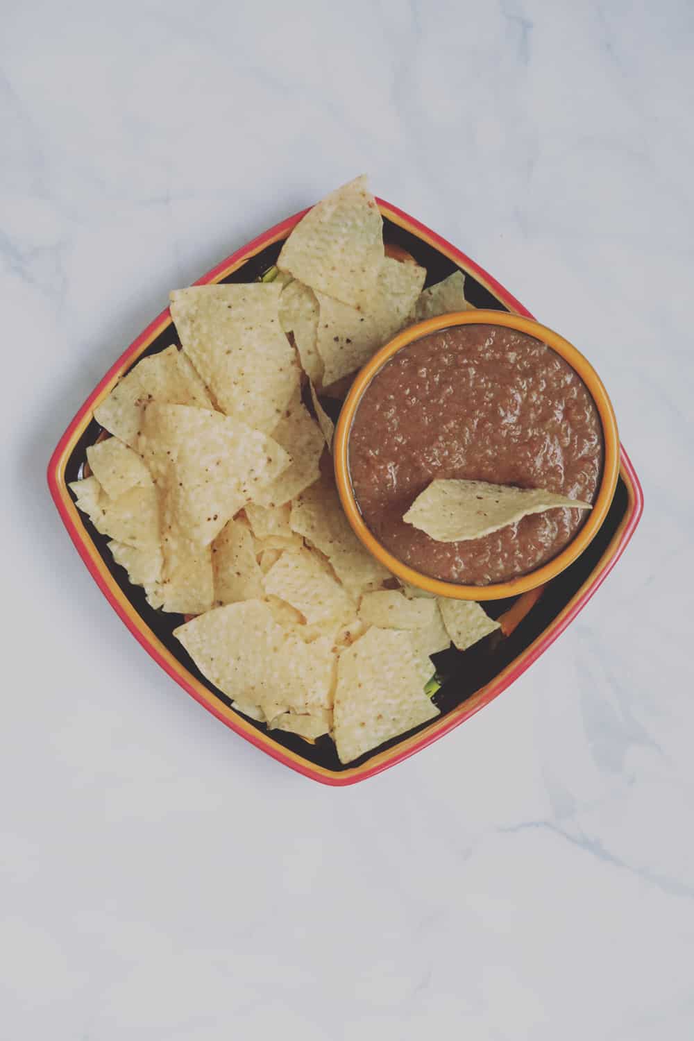 This simple slow cooker bean dip is perfect for game day snacking. Just a few ingredients and hours later you've got a deliciously easy dish!