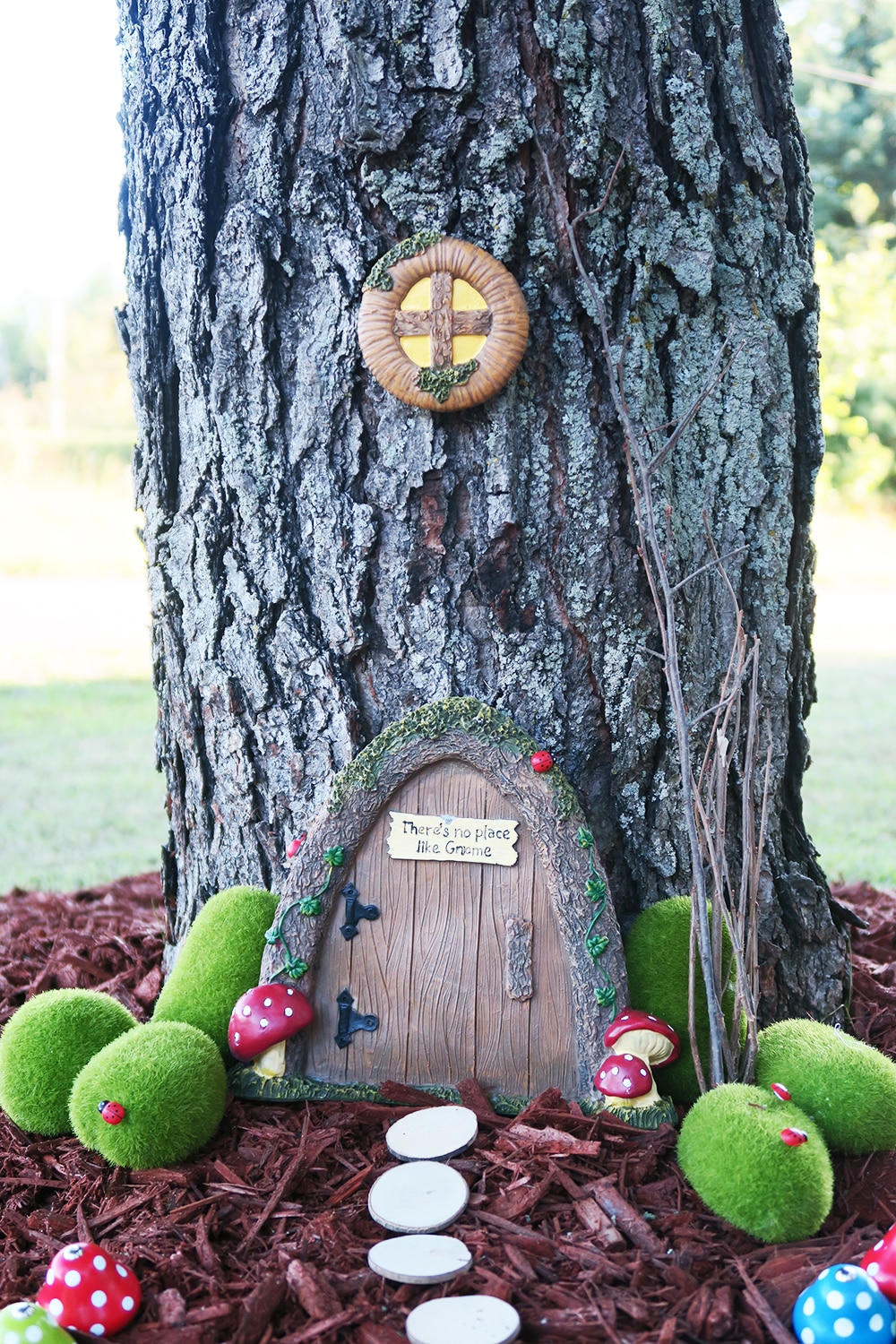 Want to add some whimsy to your yard? This simple DIY fairy garden is the answer! You'll turn your tree base into a magical scene in no time.