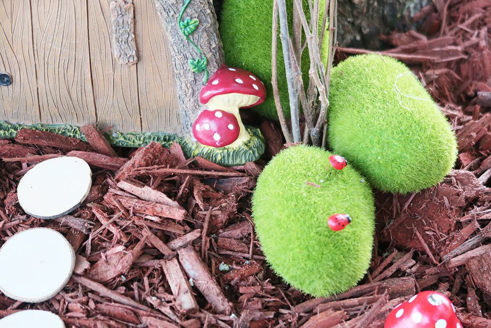 Want to add some whimsy to your yard? This simple DIY fairy garden is the answer! You'll turn your tree base into a magical scene in no time.