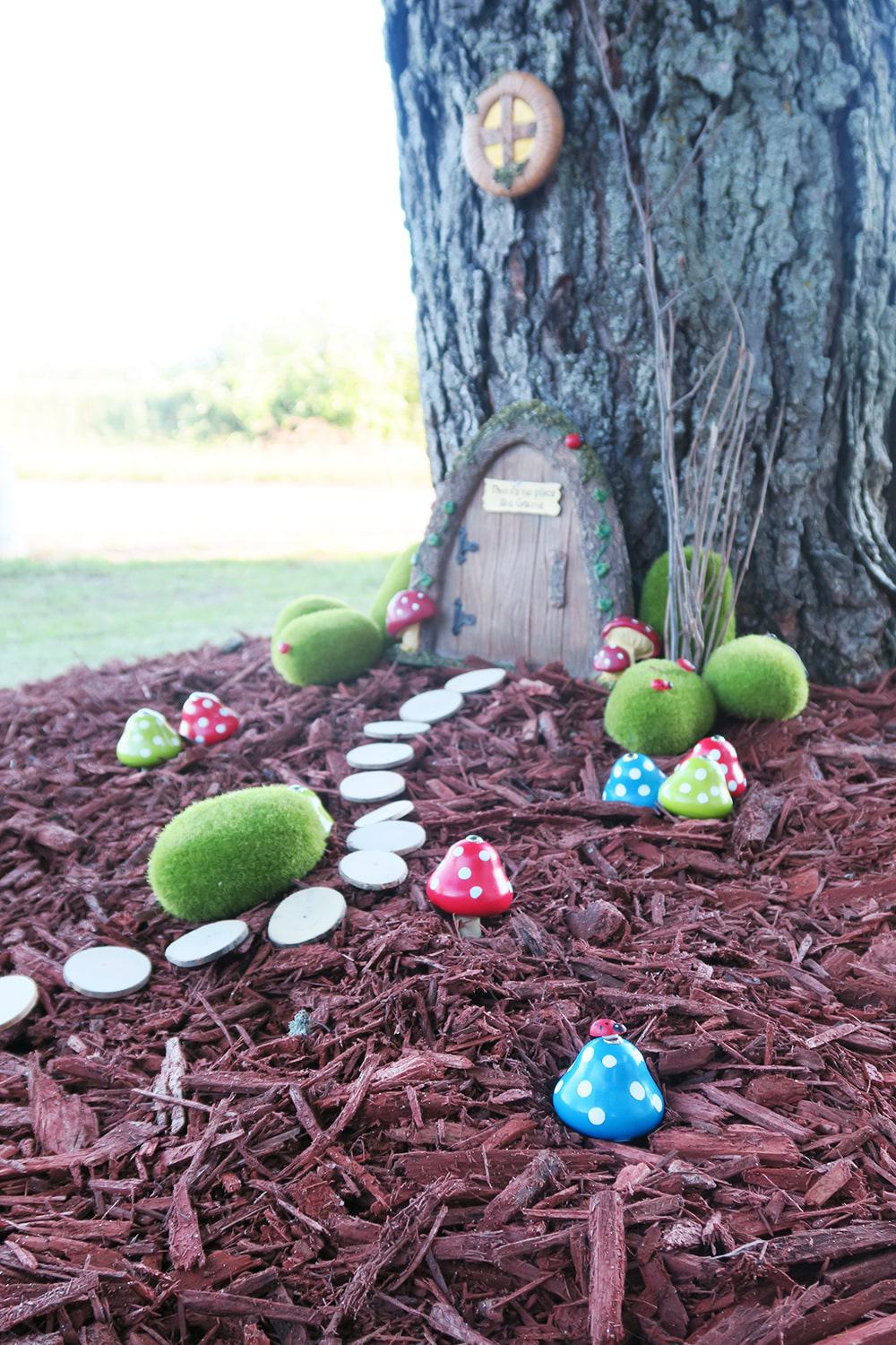 Want to add some whimsy to your yard? This simple DIY fairy garden is the answer! You'll turn your tree base into a magical scene in no time.