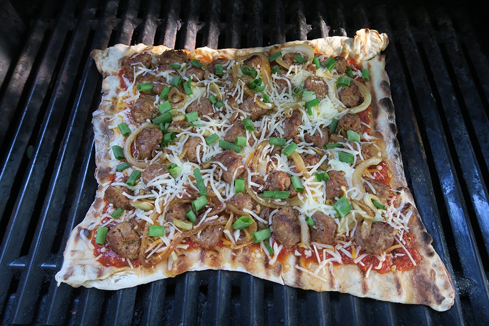 This Grilled Onion Sausage Fennel Pizza Recipe is a summer dish you won't want to miss! Made with store-bought pizza dough, dinner will be done in no time!