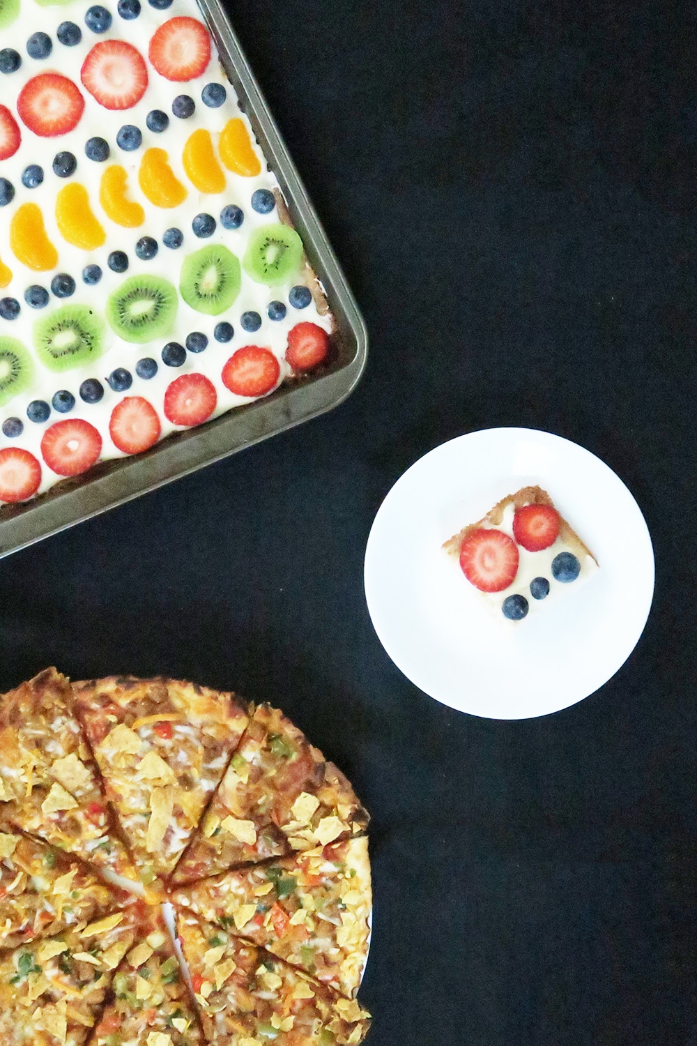 This Sugar Cookie Fruit Pizza recipe is a must-make for pizza night! It'll feed a crowd and it's super easy. This is a dessert you won't want to miss!