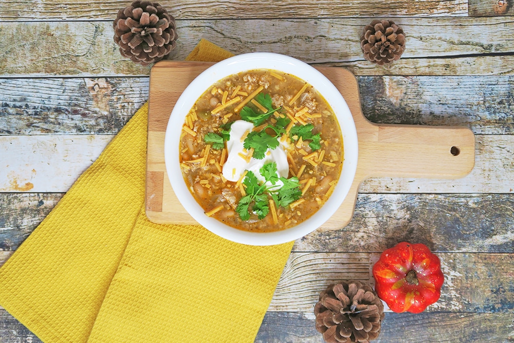 Need a hearty and healthy dish for the colder months? This Slow Cooker White Bean Turkey Chili recipe is super easy and ready in less than three hours!