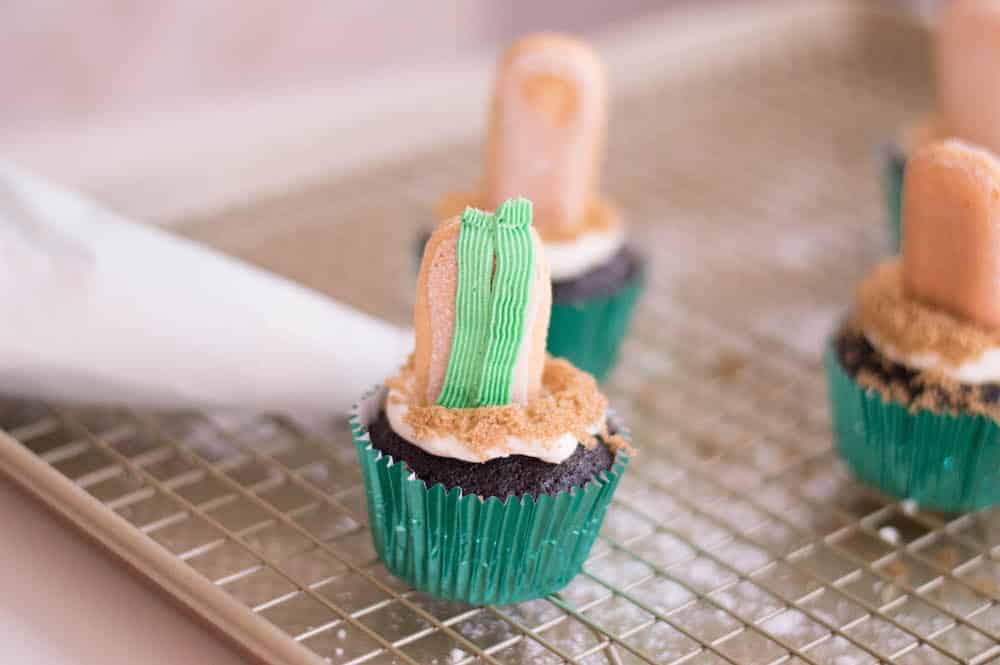 cactus cupcakes being frosted