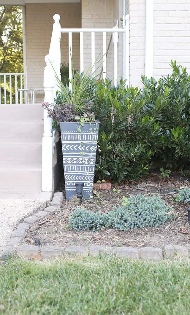 Tall planter with mud cloth pattern.