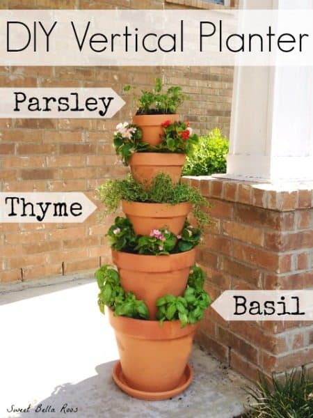 Stacked terracotta pots with fresh herbs.