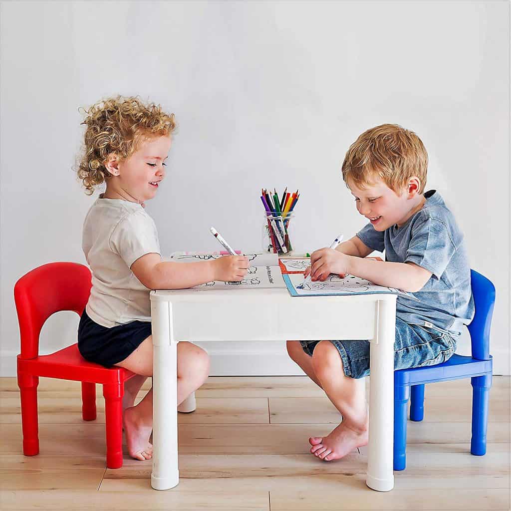girl and boy drawing at table 