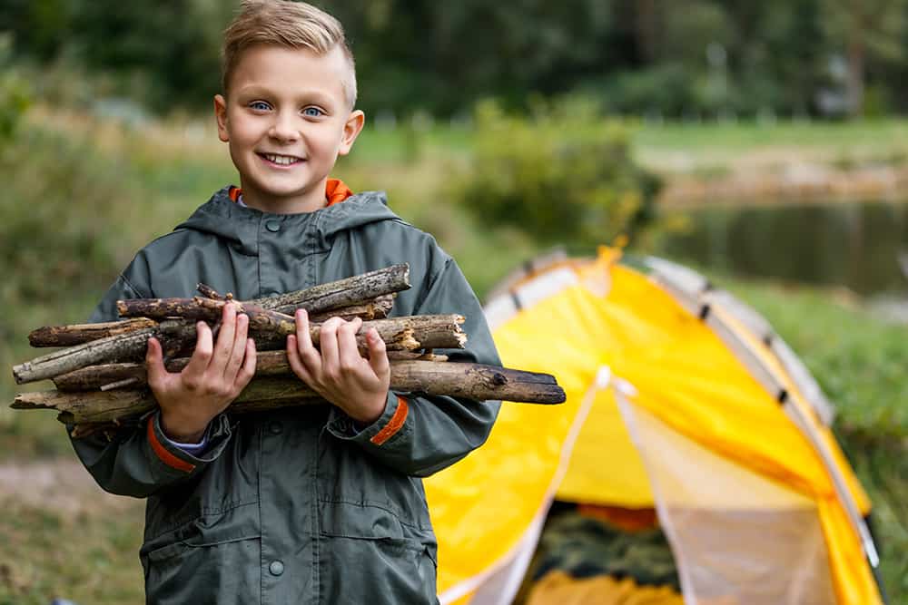 boy holding sticks