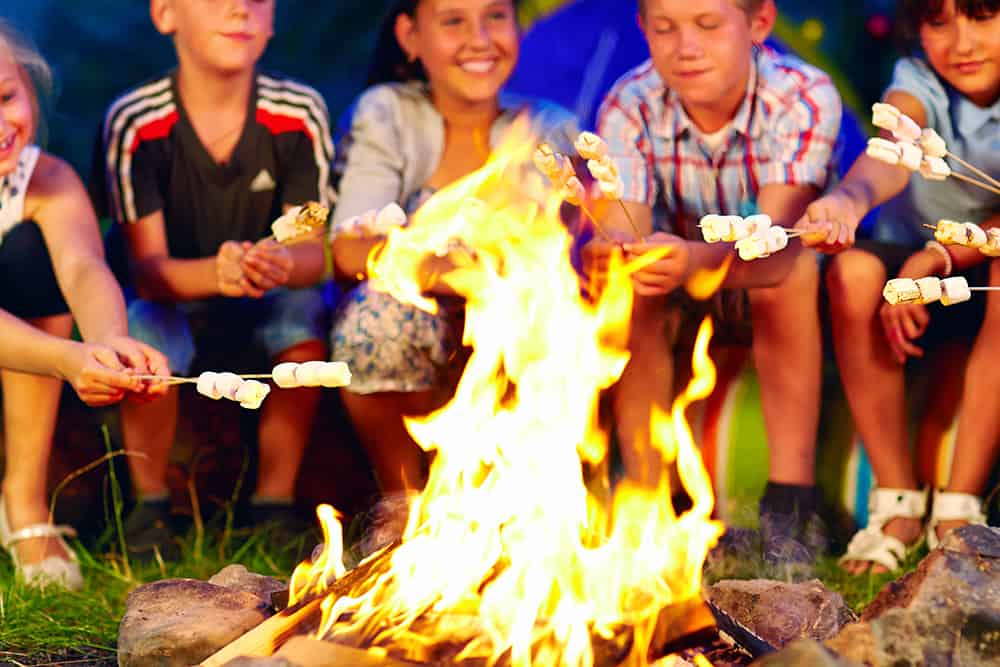 happy kids by campfire