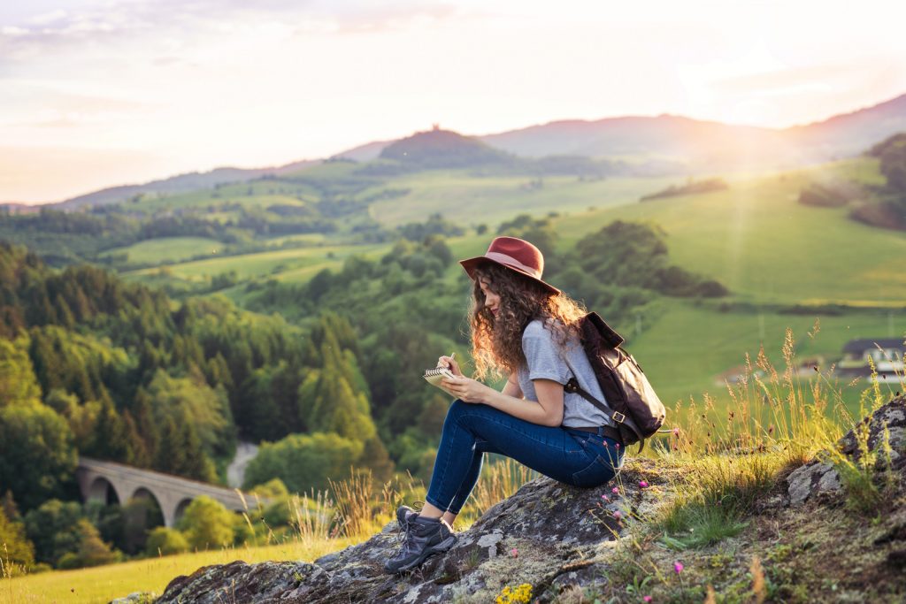 Backpacker writing in nature