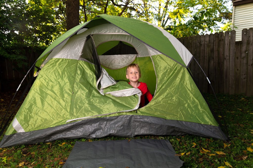 boy camping in backyard